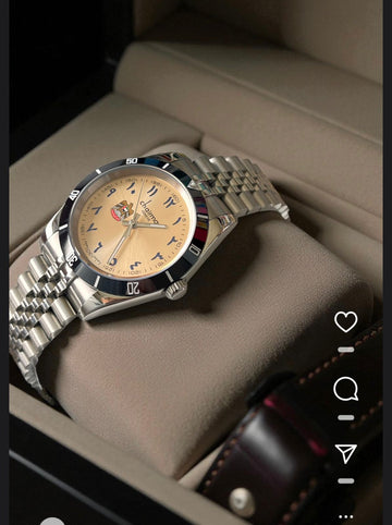 UAE Emblem Chairman Geneve Arabic Baby Orange Dial Silver Chain Gents Watch